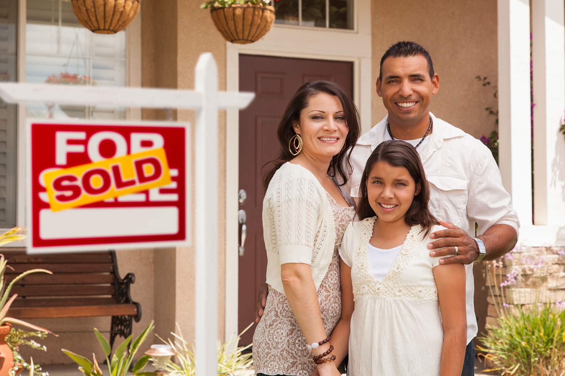 Family in front of a sold home